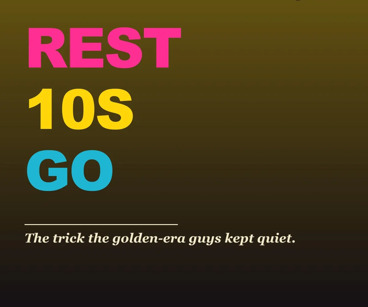 A single barbell with weight plates and a stopwatch on a gym floor