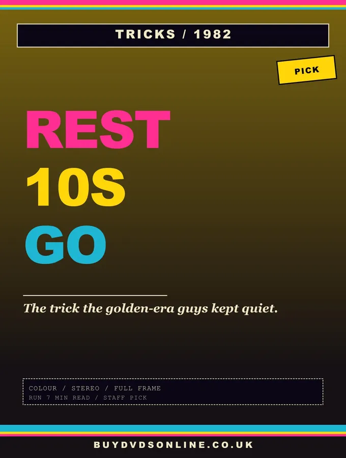 A single barbell with weight plates and a stopwatch on a gym floor